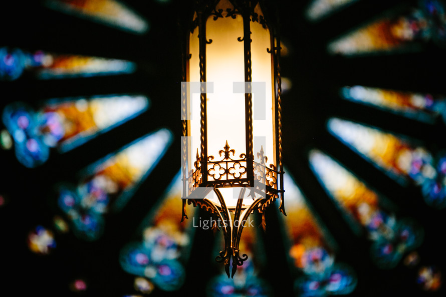 hanging lantern in a church and stained glass window 