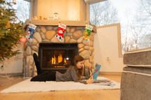a little girl reading a book at Christmas 