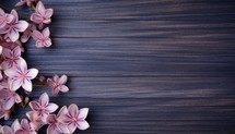 Bouquet of pink flowers on a wooden background. Place for text.