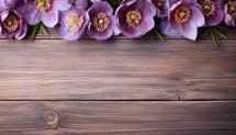 Bouquet of purple anemones on a wooden background.