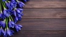 Bouquet of blue flowers on wooden background. Top view with copy space