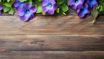 Morning glory flowers on wooden background. Top view with copy space.