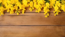 Bouquet of yellow freesia flowers on a wooden background