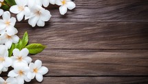 White jasmine flowers on wooden background. Top view with copy space