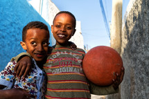 children holding a ball 