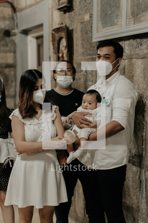 a family at their infants baptism 