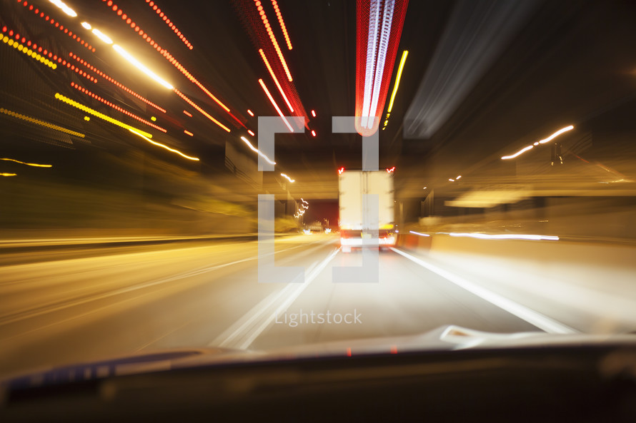 A car driving on a motorway at night	