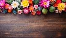 Colorful Cactus flowers on brown wooden background with copy space.