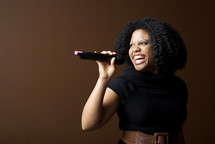 woman singing into a microphone 