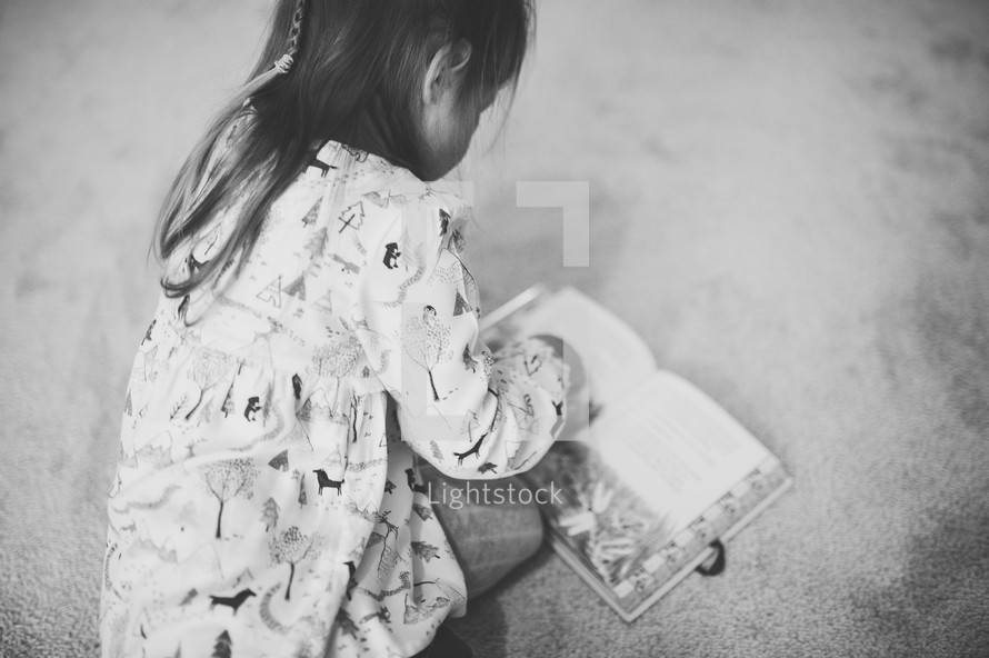girl reading a Children's Bible with her daughter 