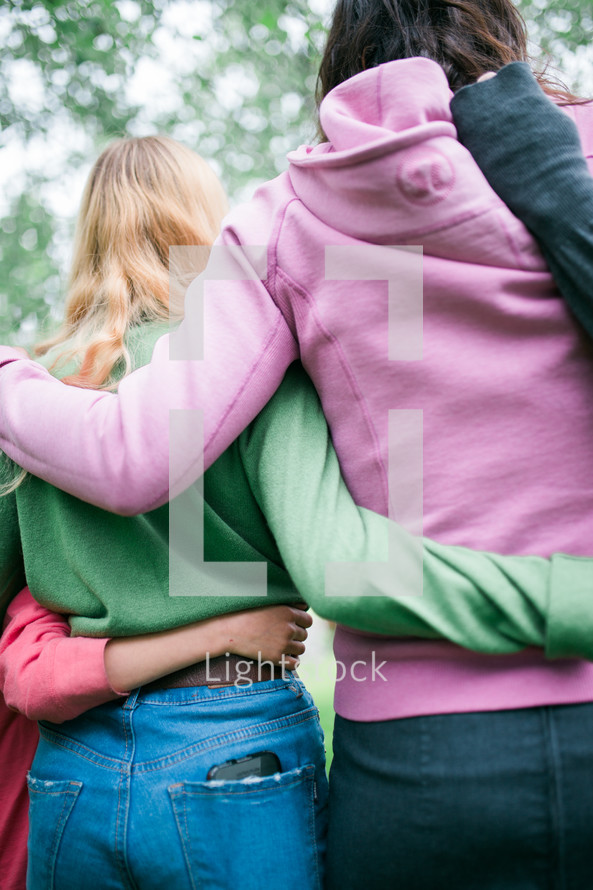 women with arms around each other 