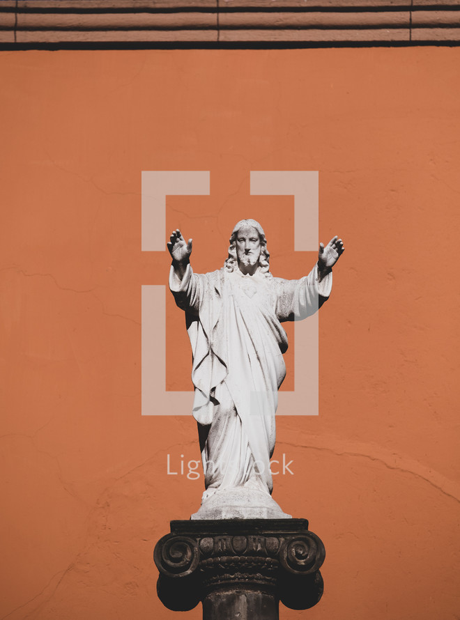 statue of Jesus with hands raised 