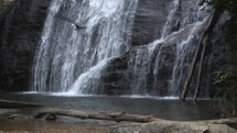 a man sitting and watching a waterfall 