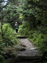 woman walking on a forest trail in Asheville, NC 