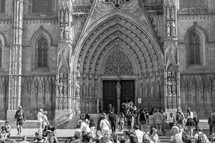 people entering doors of a cathedral 