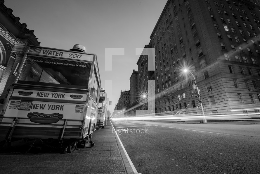 city buses parked along the street in NYC 