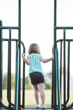 young girl playing on a playground 