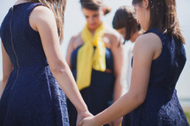 mother and daughters holding hands in prayer 