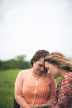 mother and daughter in prayer together