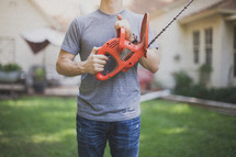 man holding a hedge trimmer