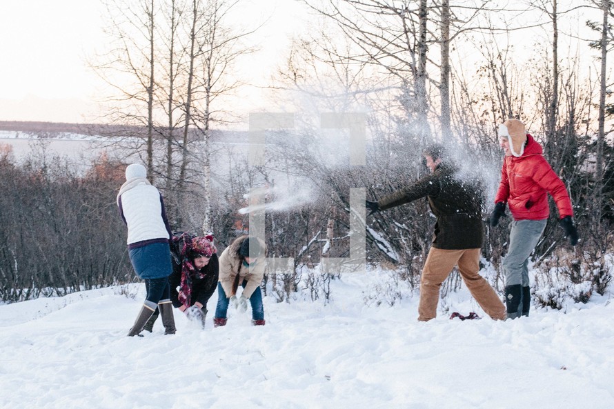 snowball fight outdoors in winter snow 