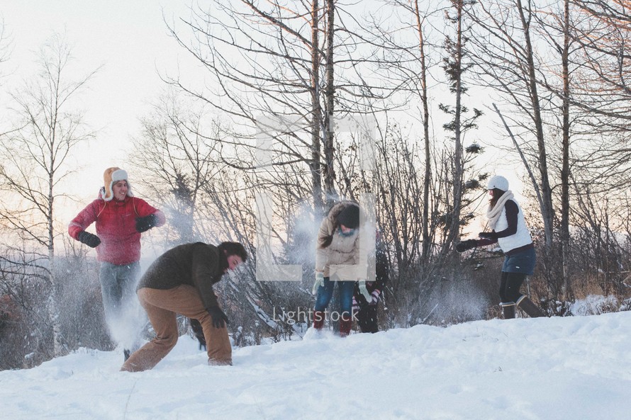 Young people having a snowball fight.