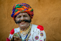 man with painted face and turban in India 