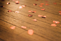 heart shaped confetti on wood 