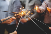 people holding sparklers at a wedding 