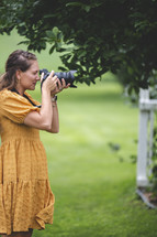 a woman with a camera taking pictures 