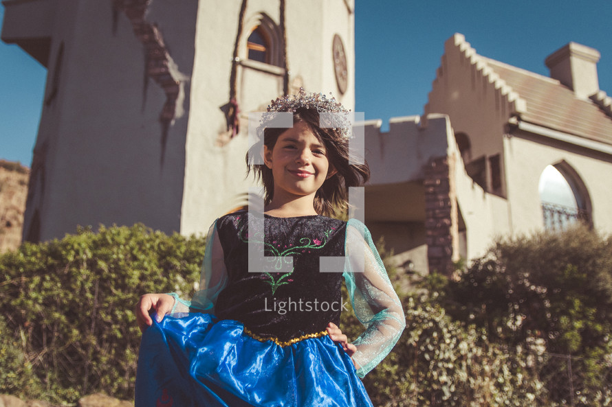 a girl dressed up as a princess in front of Claren's castle 