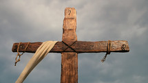 Cross with ropes and cloudy sky - detail