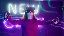 Woman moving her arms around while playing a virtual reality game.