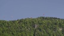 Paraglider flying near hill