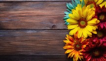 Colorful sunflowers on wooden background. Top view with copy space