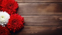 Red and white chrysanthemums on a brown wooden background