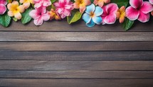 Plumeria flowers on wooden background with copy space for text.