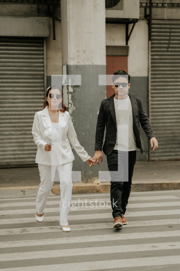 bride and groom using a crosswalk 