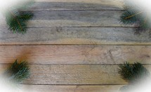 Border of Spruce branches on wooden background 