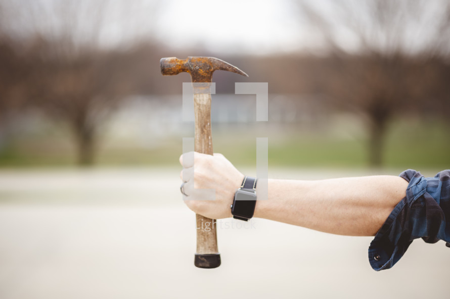 a man holding a hammer 
