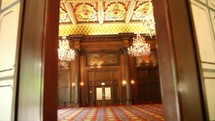 chandeliers hanging in a grand ballroom 