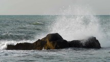 Rough sea crushing the rocks with high splashes