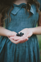 girl with a handful of blackberries 
