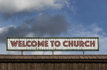 Welcome to Church sign on the roof of a building 