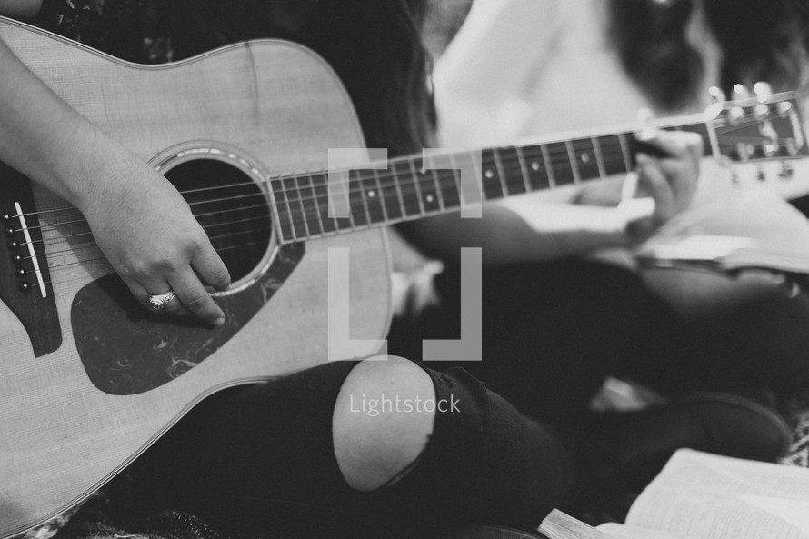 young woman playing a guitar 