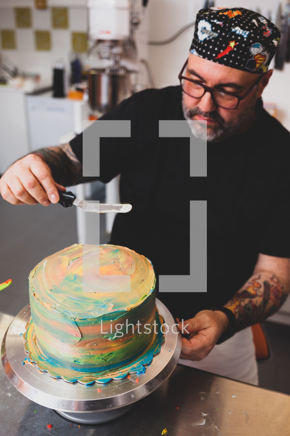 man icing a cake 