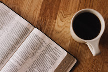 An open Bible and a cup of coffee.