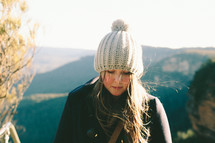 woman in a knit hat looking down 