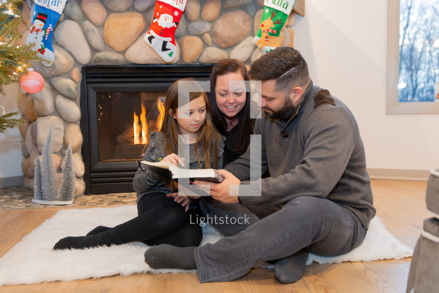 family reading a Bible together at Christmas 