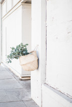 eucalyptus in a basket hanging on a wall 